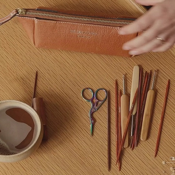 ReDesigned PROJECT 11 is a small triangular leather Tool Case for knitting needles or crochet hooks. Burned tan