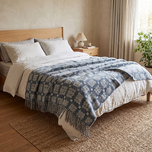 Craig Goch Welsh Blanket. Draped over a double bed in a modern bedroom