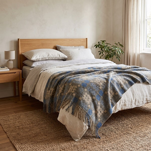 Dunraven Welsh blanket. Draped over a double bed in a modern bedroom.