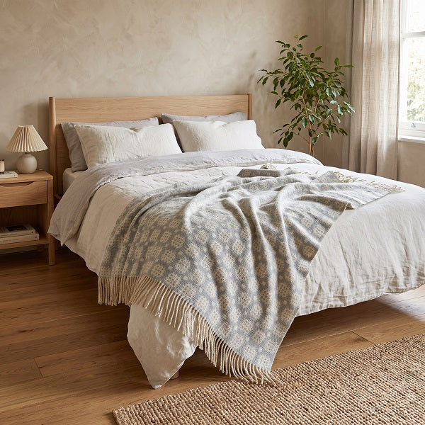 Maldwyn Welsh Blanket. Draped over a double bed in a modern bedroom