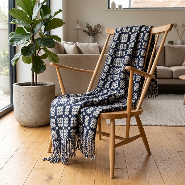 Bodnant Welsh blanket. Draped over a wooden chair in a modern living room