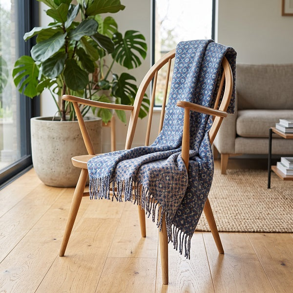 Pen y Fan Welsh blanket. Draped over a wooden chair in a modern living room