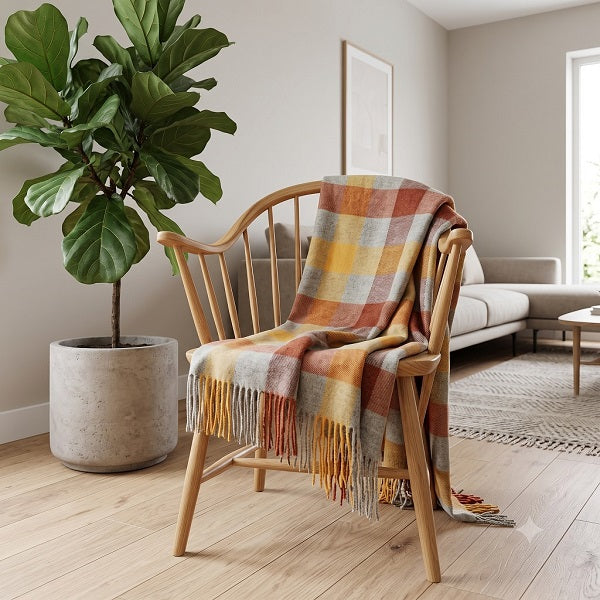 Welsh blanket named Gower on a Wooden chair draped over it in a living room setting.