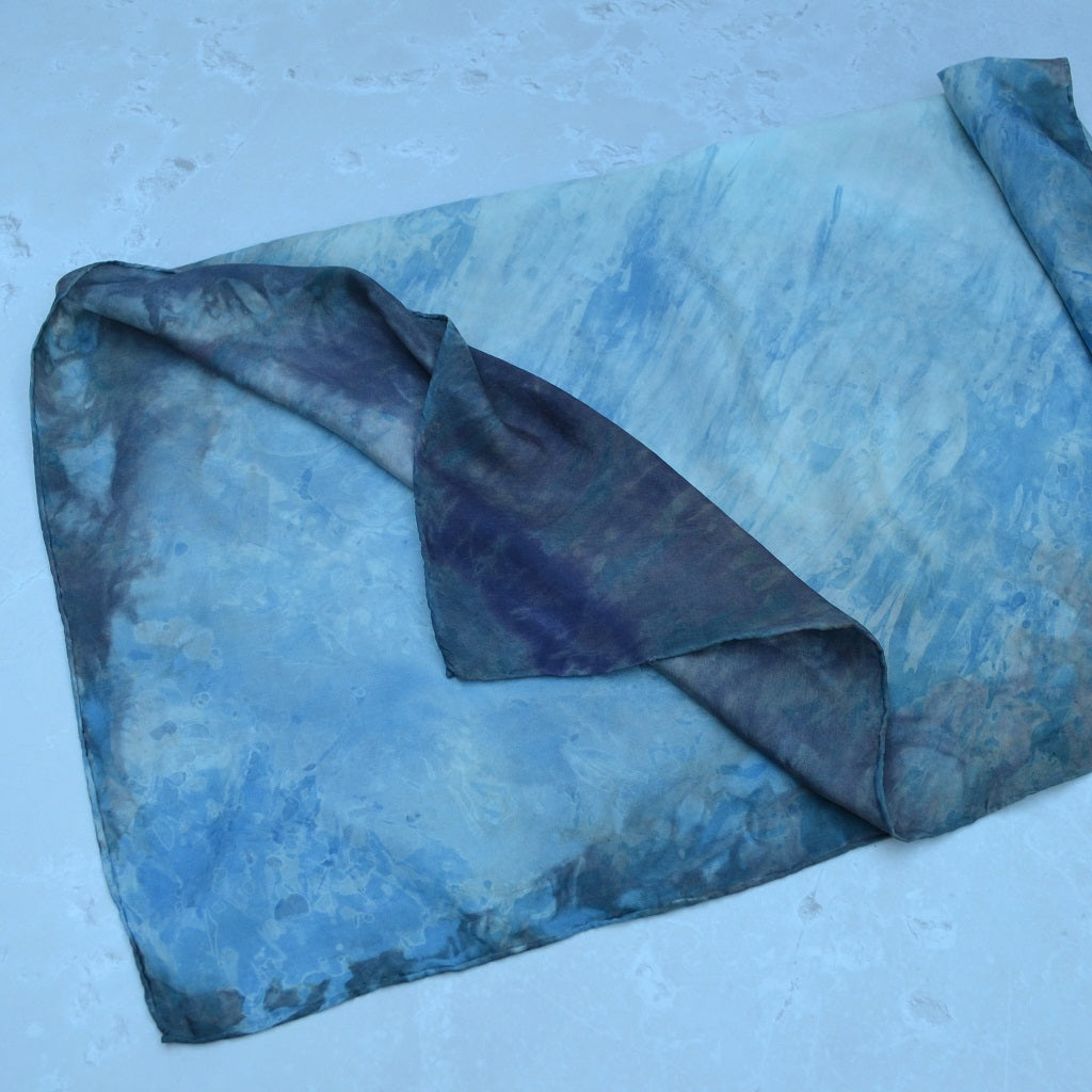 A beautiful silk scarf hand dyed in a resist using a variety of natural dyes. The result is a soft flow of colour and resist patterns throughout the piece 2