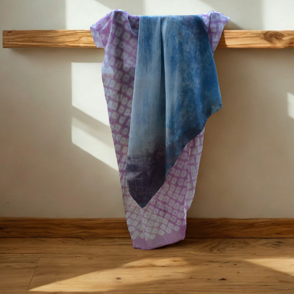 A beautiful silk scarf hand dyed in a resist using a variety of natural dyes. The result is a soft flow of colour and resist patterns throughout the piece 1