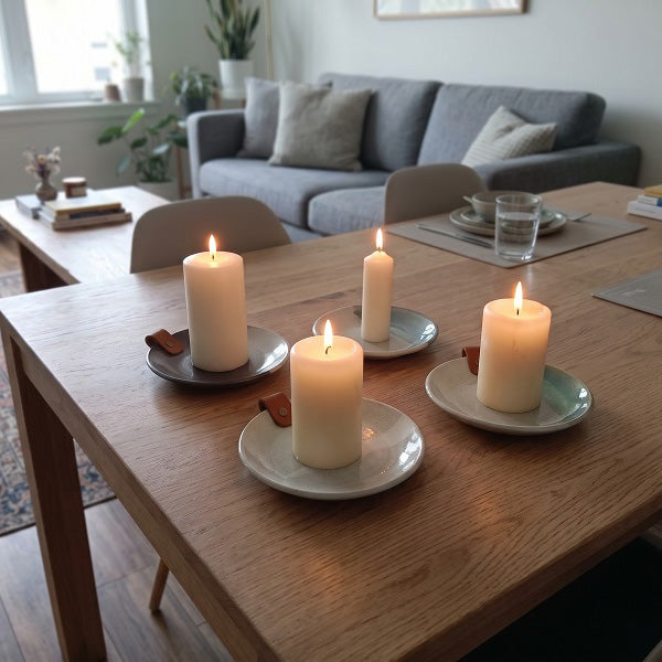 Handmade stoneware candle plates with leather strap. In four glaze colours  