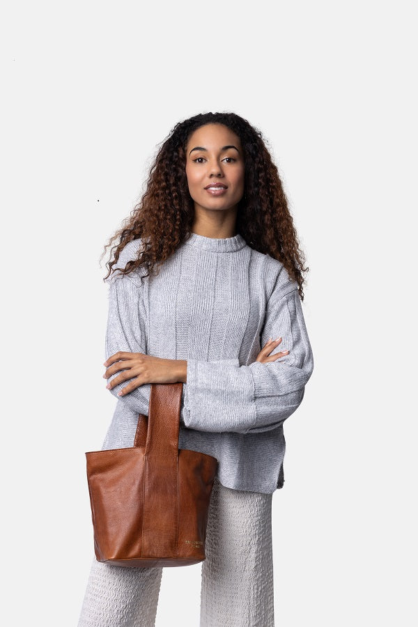 Redesigned project 81 - Woman holding a brown leather tote bag 