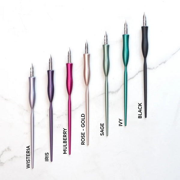 Toms Studios Flourish Straight Version Calligraphy Pens - Set of colourful fountain pens on a marble surface with colour labels.