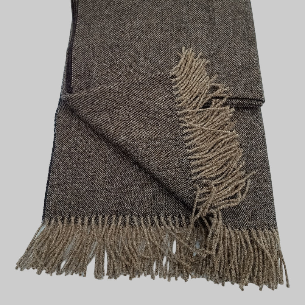 Welsh blanket, Neyland. Brown woven blanket with fringes on a light grey background