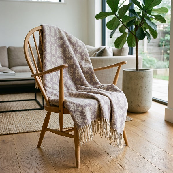 Rhosili Welsh blanket. Draped over a wooden chair in a modern living room