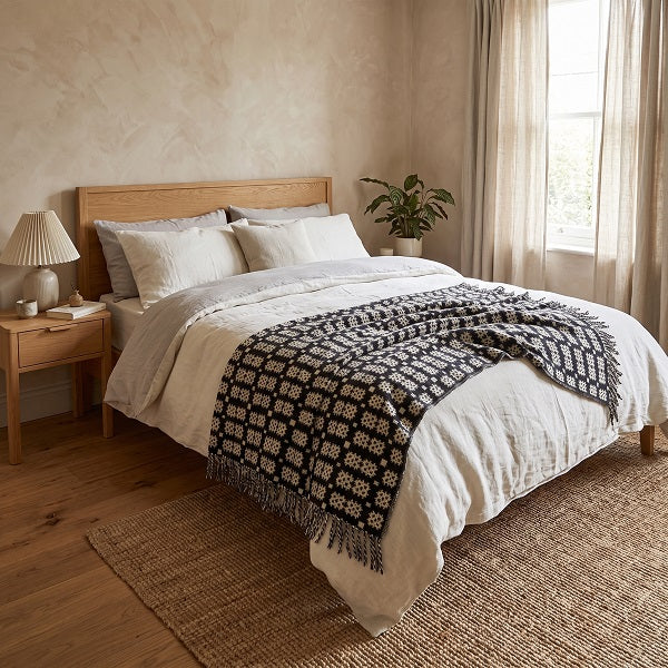 Aur Cymru - Welsh Gold Welsh Blanket. Draped over a double bed in a modern bedroom