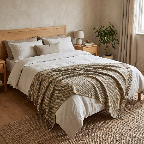 Penarth Welsh blanket. Draped over a double bed in a modern bedroom.