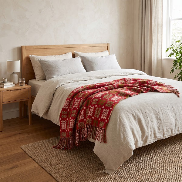 Preseli Welsh blanket. Draped over a double bed in a modern bedroom.