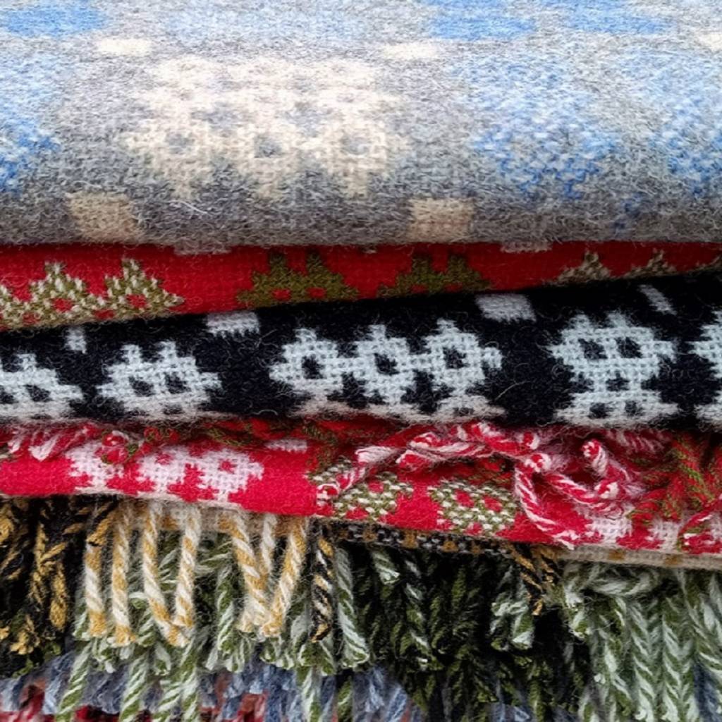 Welsh blankets. Stack of patterned blankets with various colours and designs. 
