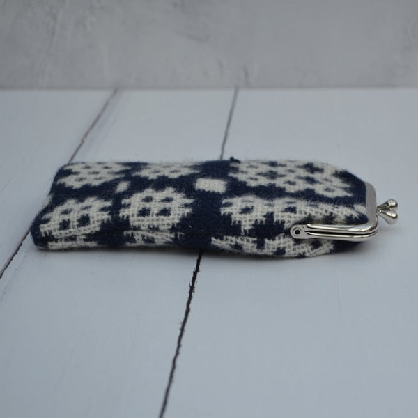 A collection of Welsh tapestry eye glasses cases with metal clasp, displayed on a white surface. The cases feature various traditional Welsh patterns and colours..