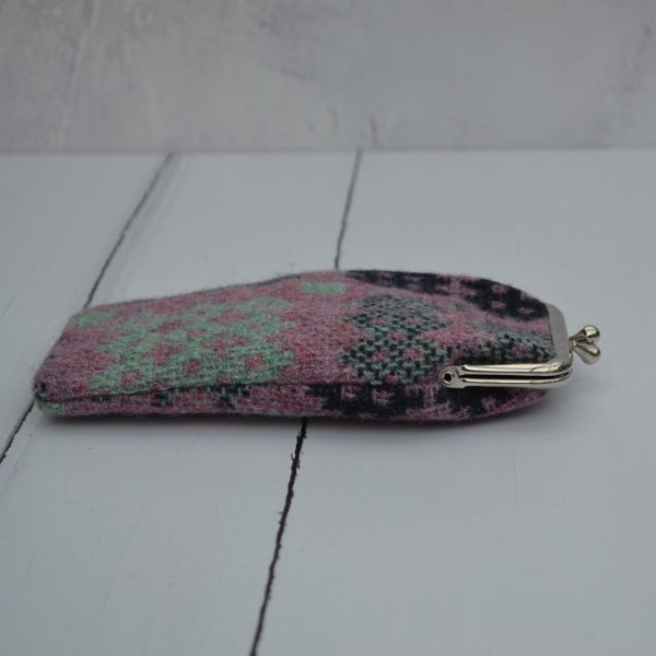 A collection of Welsh tapestry eye glasses cases with metal clasp, displayed on a white surface. The cases feature various traditional Welsh patterns and colours...