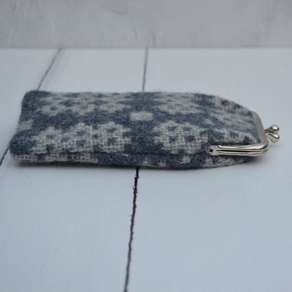 A collection of Welsh tapestry eye glasses cases with metal clasp, displayed on a white surface. The cases feature various traditional Welsh patterns and colours  ....