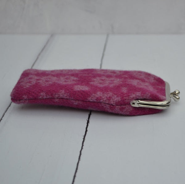 A collection of Welsh tapestry eye glasses cases with metal clasp, displayed on a white surface. The cases feature various traditional Welsh patterns and colours......    