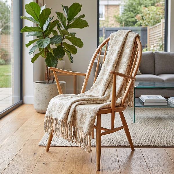 Claerwen Welsh blanket  draped over a wooden chair in a modern living room