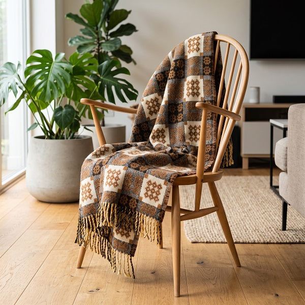 Cwm Gwaun Welsh blanket. Draped over a wooden chair in a modern living room
