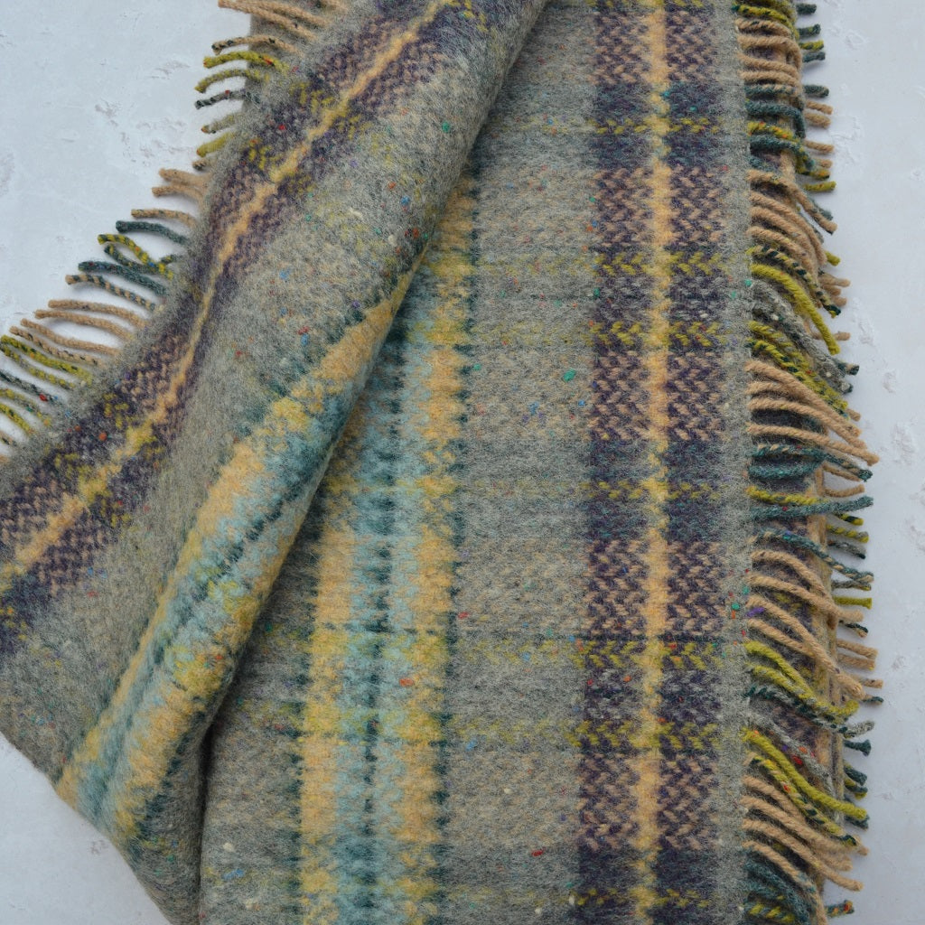 Plaid fabric with fringes on a white background