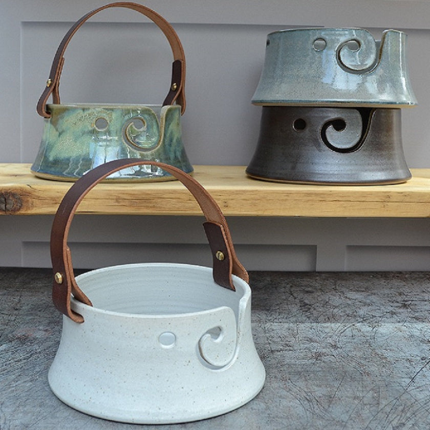 Stoneware pottery handmade yarn bowls featuring our distinctive leather handles in a variety of designs and glaze colours.